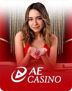 Female AE Casino live dealer in red holding dice, seated in an elegant red-themed studio
